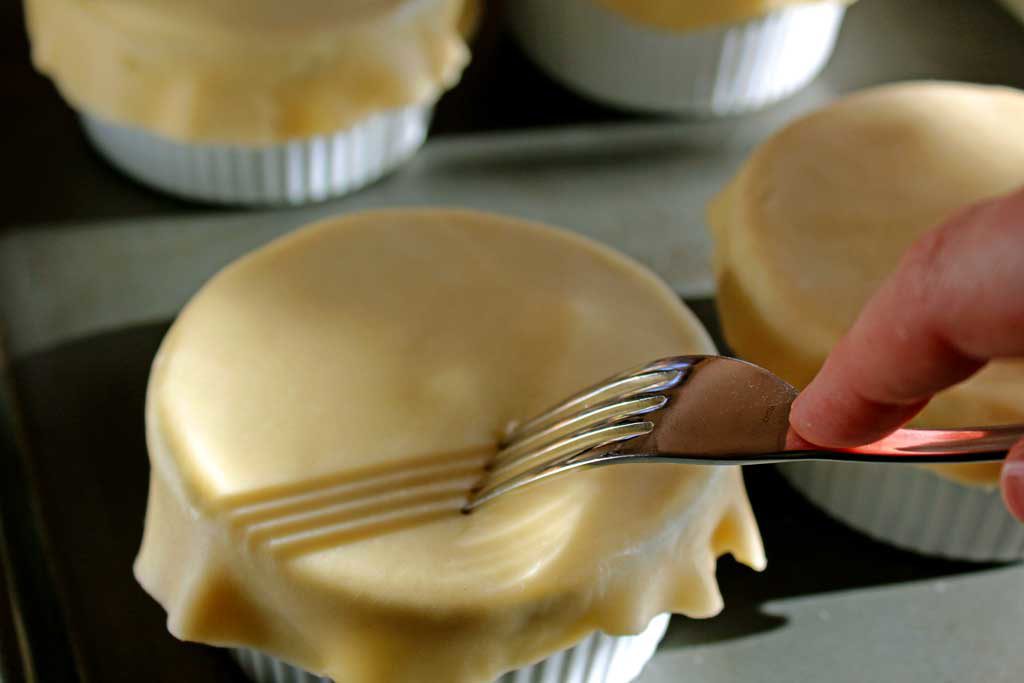 poking holes into the top layer of pastry dough