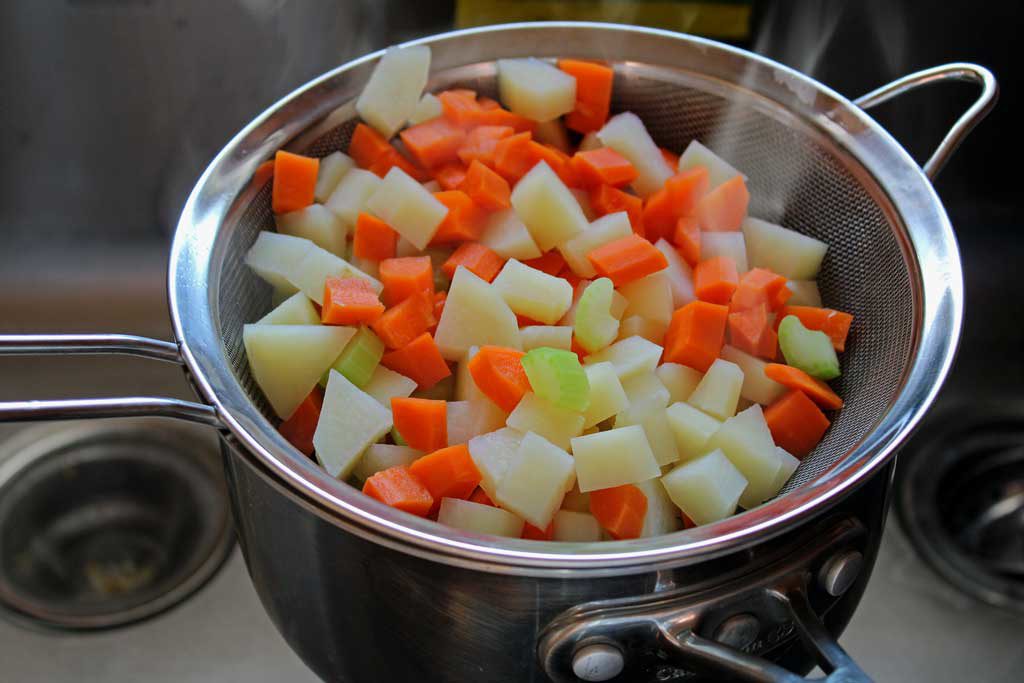 steaming veggies in a sieve
