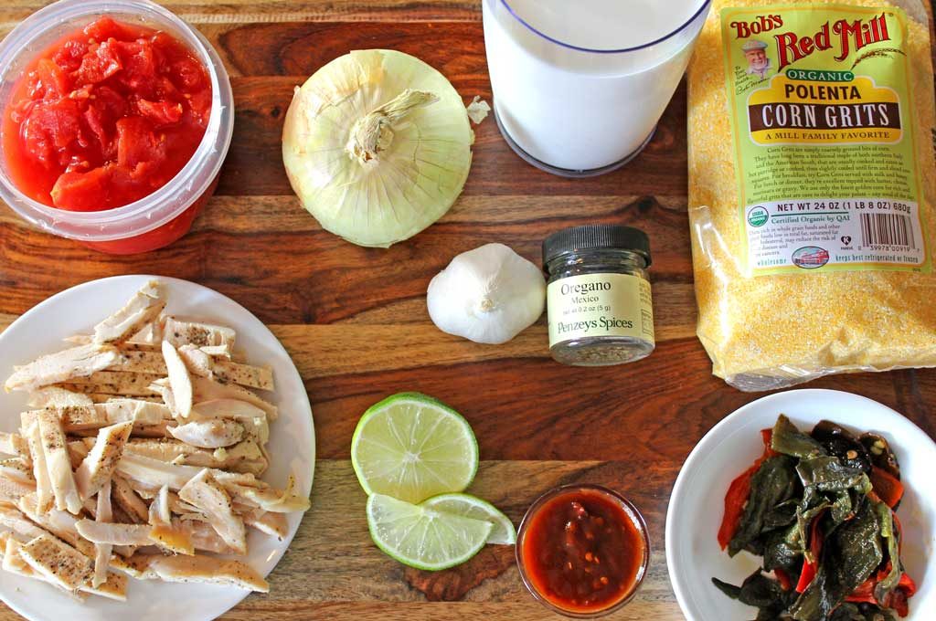 Spicy chicken poblano stew with polenta puts a Mexican spin on Italian food. With only 389 calories per serving, this hearty weeknight dish is made of shredded chicken, stewed with smoky poblanos, and onions in a garlicky tomato sauce spiced up with adobo sauce, served over creamy sweet porridge of polenta. | TheMountainKitchen.com