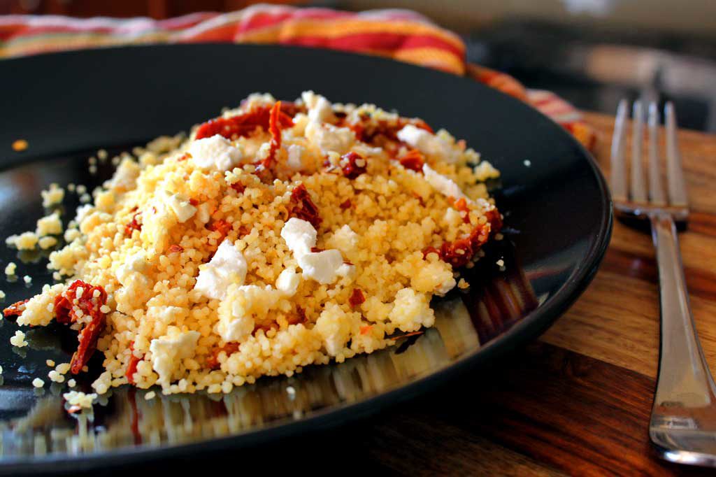 This Mediterranean Couscous gets wonderful flavor from chicken broth, sweet and tangy sun-dried tomatoes, feta cheese and a touch of heat red pepper flakes. | TheMountainKitchen.com