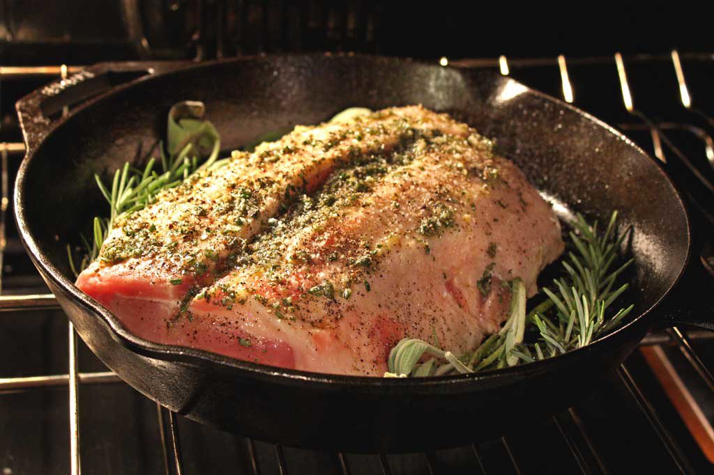 There is nothing like a well-seasoned incredibly tender pork roast, pan-seared with herbs and garlic oven-roasted to perfection. Roasted pork is amazing! | TheMountainKitchen.com