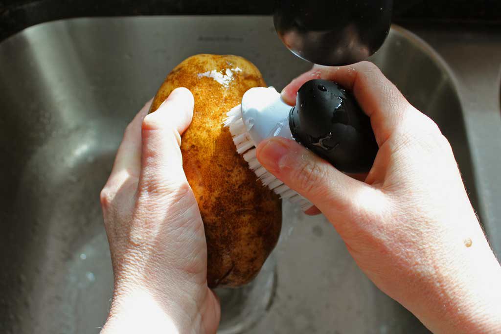 scrubbing potato