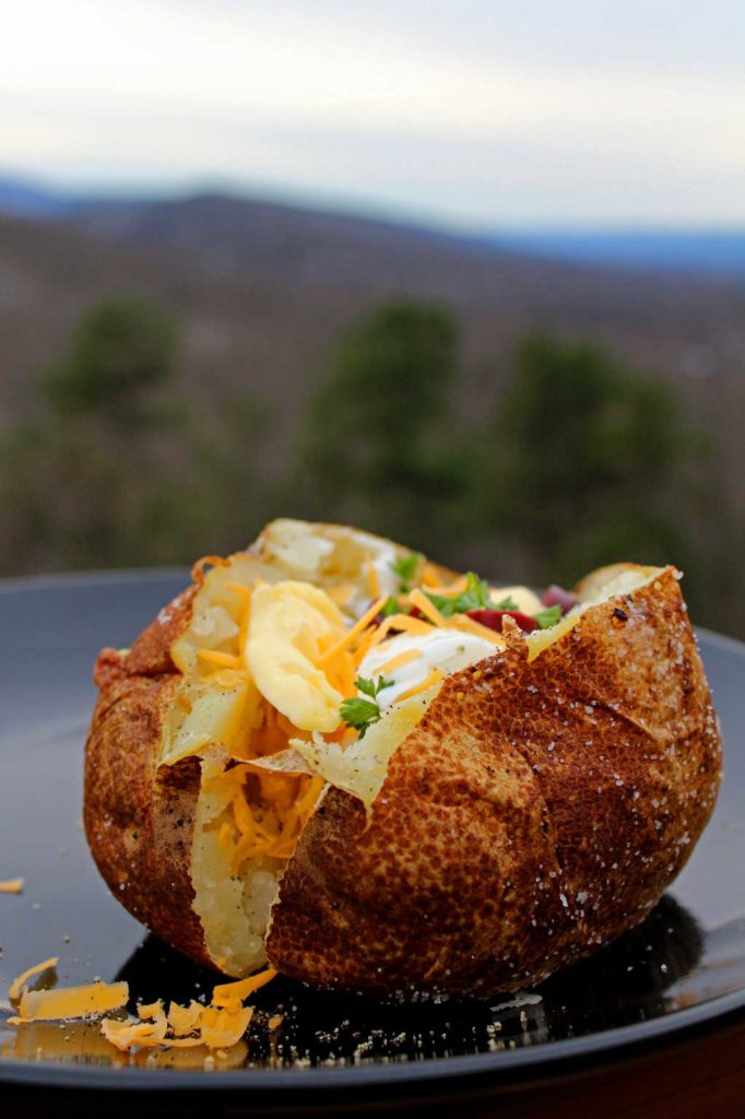 Steakhouse baked potato with toppings and mountain view