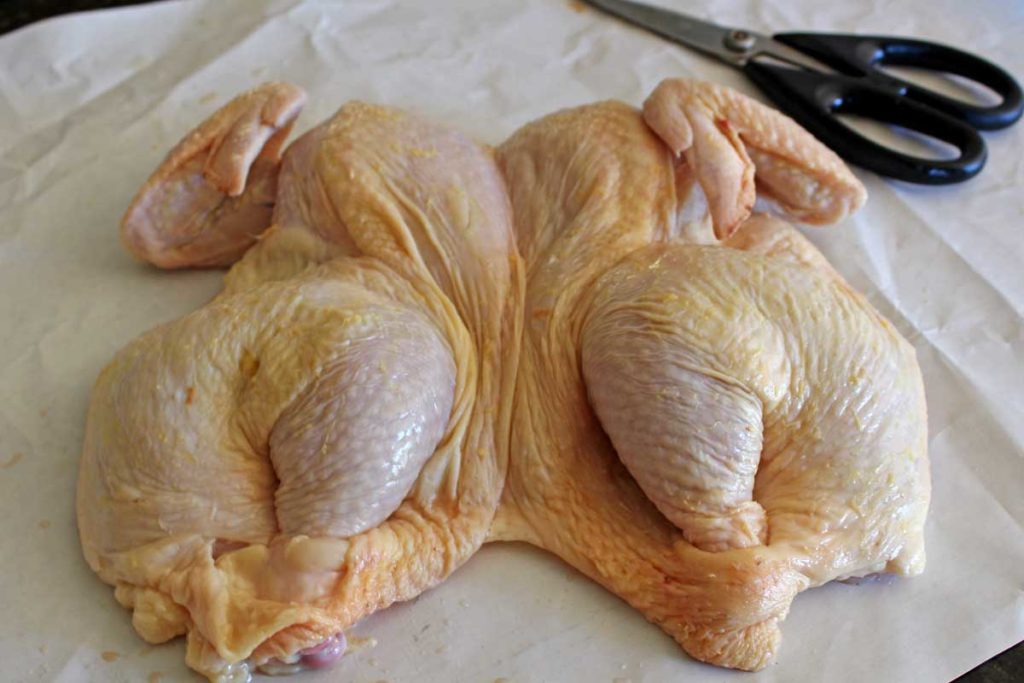 a spatchcocked chicken ready for the grill