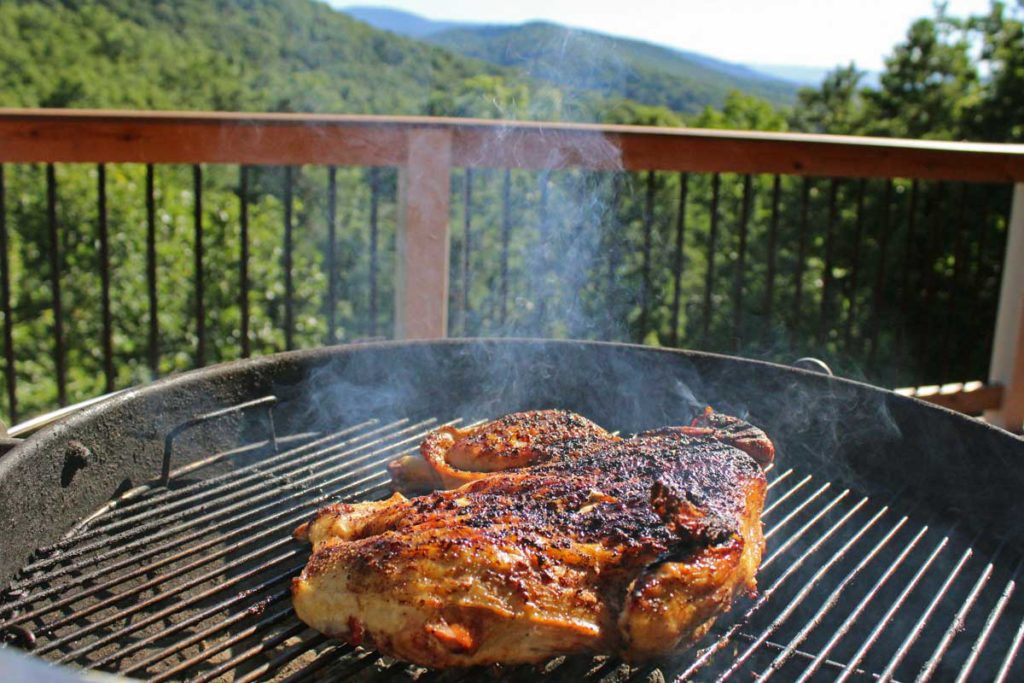 grilled spatchcock chicken on a charcoal grill