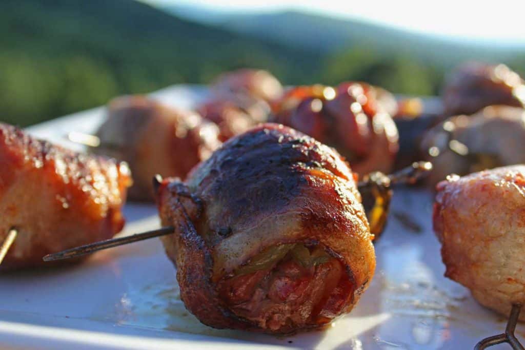 Bacon wrapped dove poppers a great way to celebrate the hunt! A great balance of grilled fatty bacon, tangy chilies, savory-sweet garlic, and smoky meat.