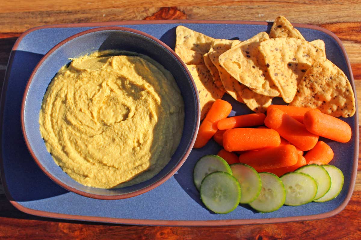 Curry hummus gets extra creaminess from greek yogurt and warm earthy spice from madras curry. A healthy snack packed with protein and fiber. It's addictive!