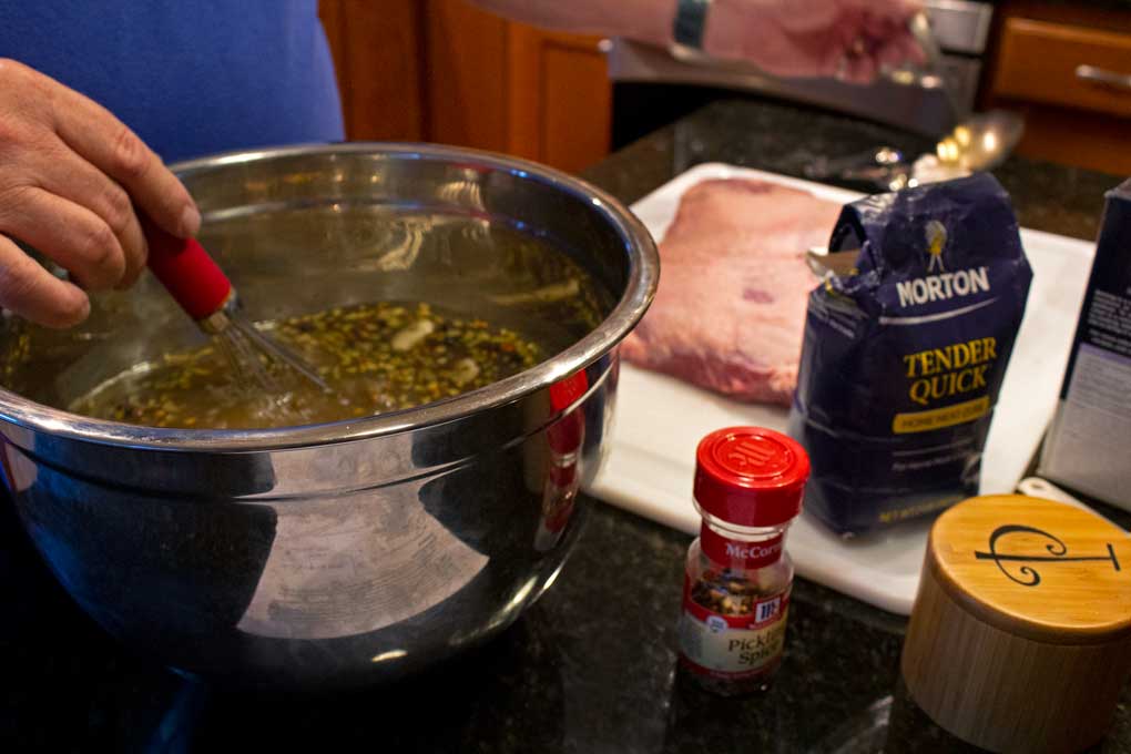 whisking brine together with brisket and ingredients