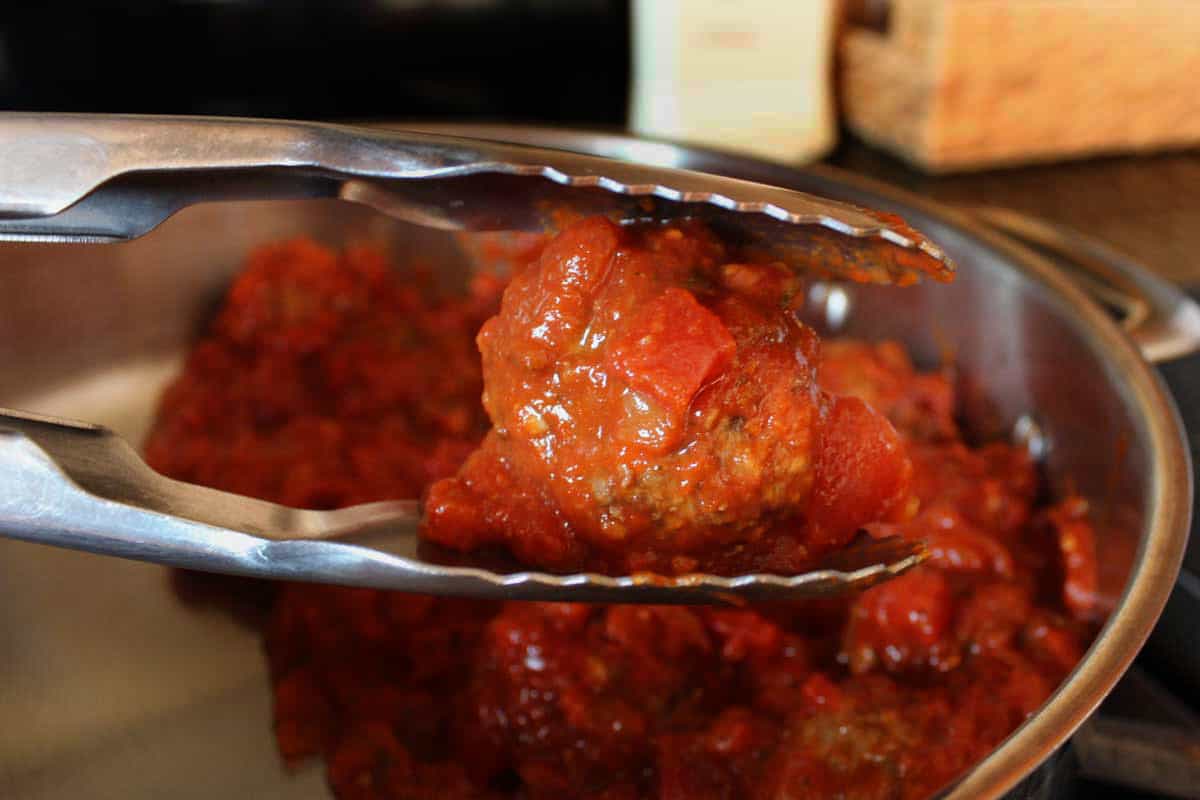 tongues holding meatball