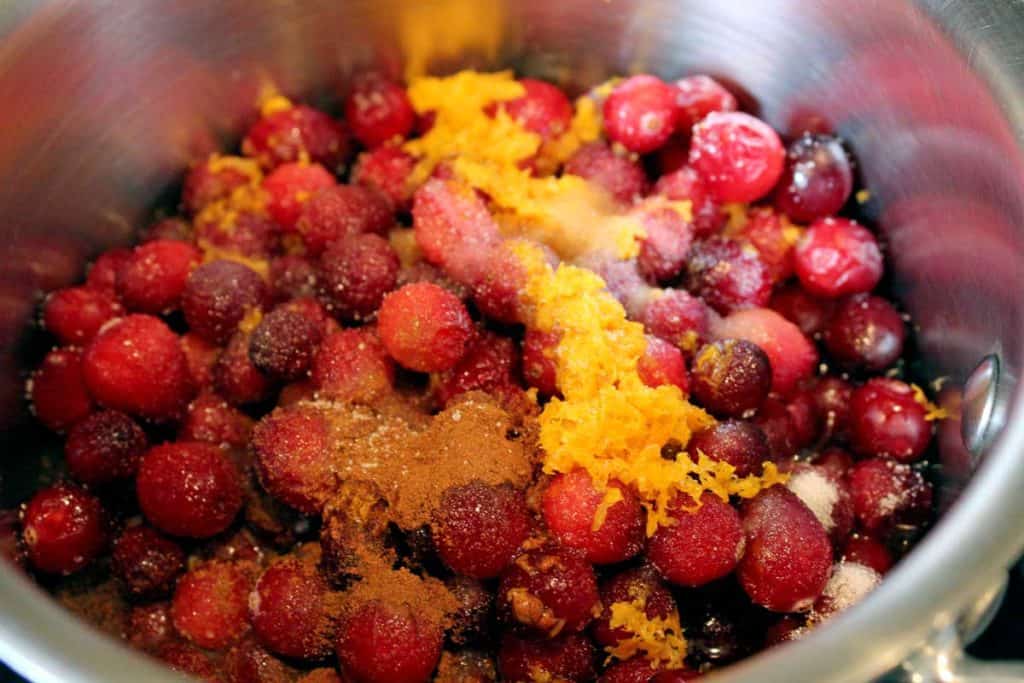 cranberries and orange zest in saucepan