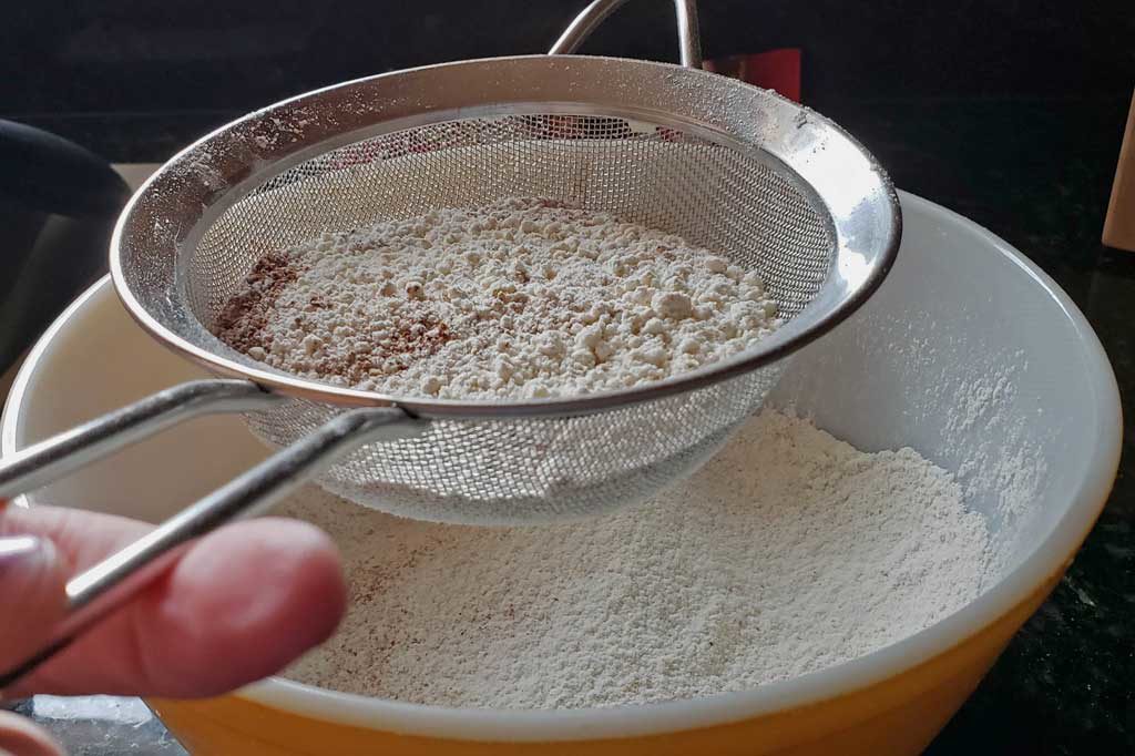 sifting flour into bowl