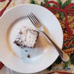 gingerbread cake on plate with fork and holiday placemat