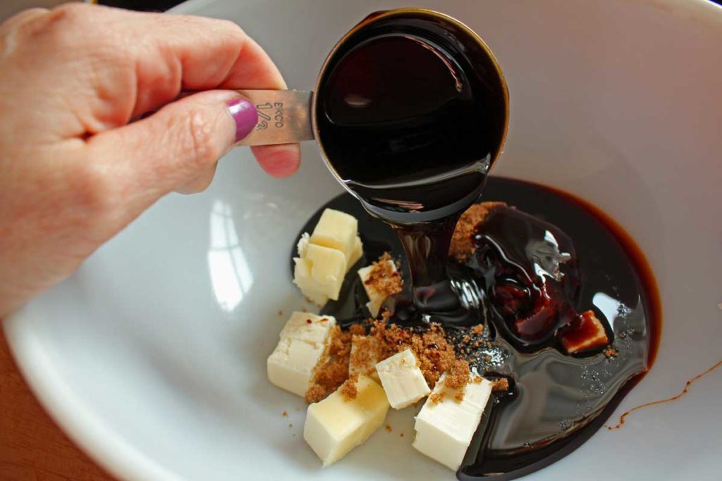 adding molasses to bowl