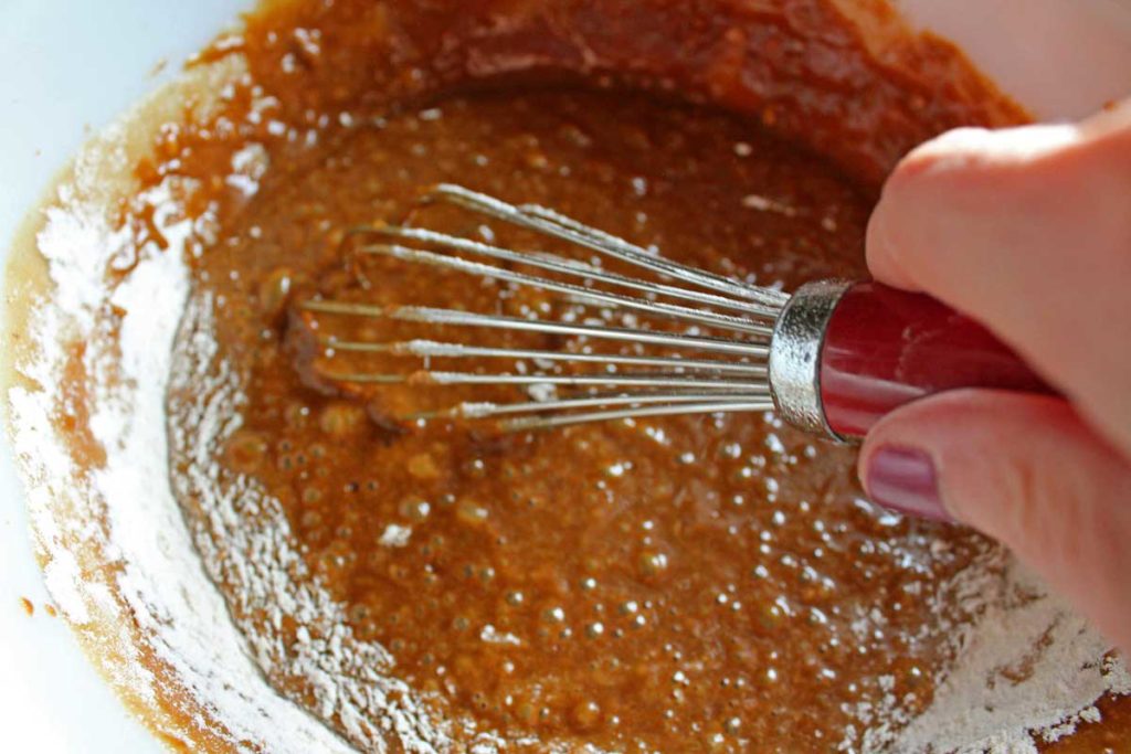 gingerbread cake batter with whisk in bowl