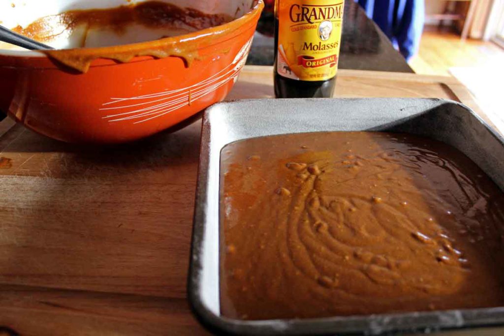 messy mixing bowl molasses and batter in pan