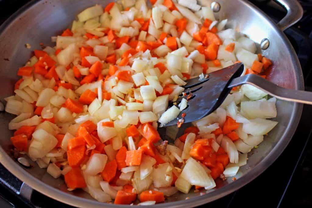 Hot Italian sausage is the star ingredient of this sausage ragu which lends rich layers of flavor simmered with mild tomatoes and seasoned vegetables.