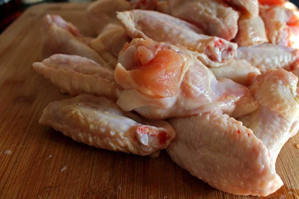 a pile of raw chicken wings