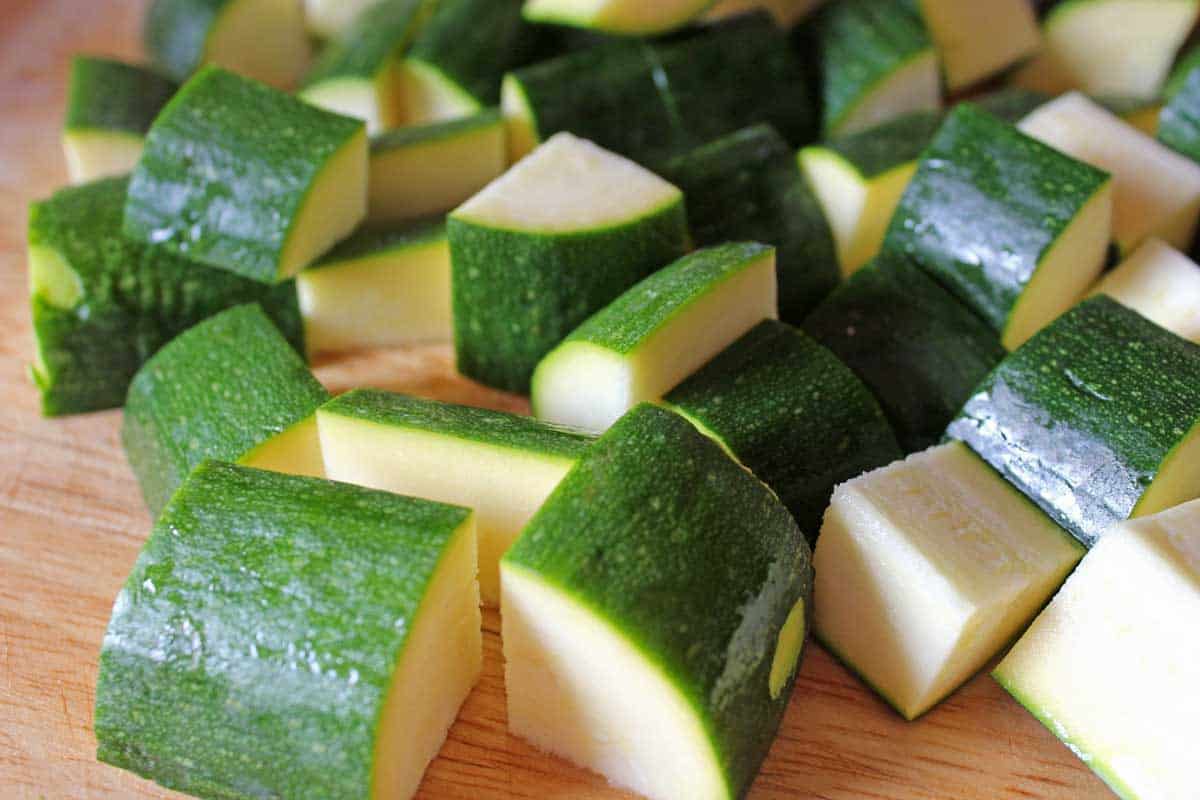 Diced zucchini on a cutting board.