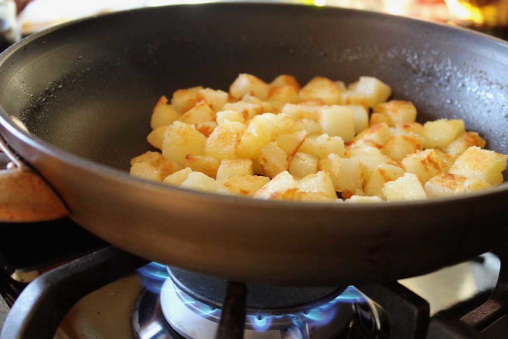 potatoes browning in a skillet