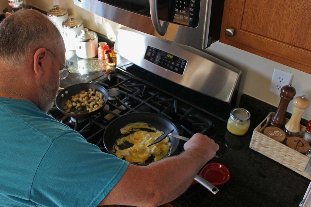 David scrambling eggs for the breakfast burritos.