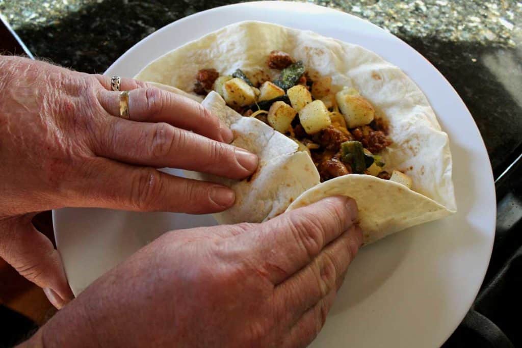 rolling up the breakfast burrito