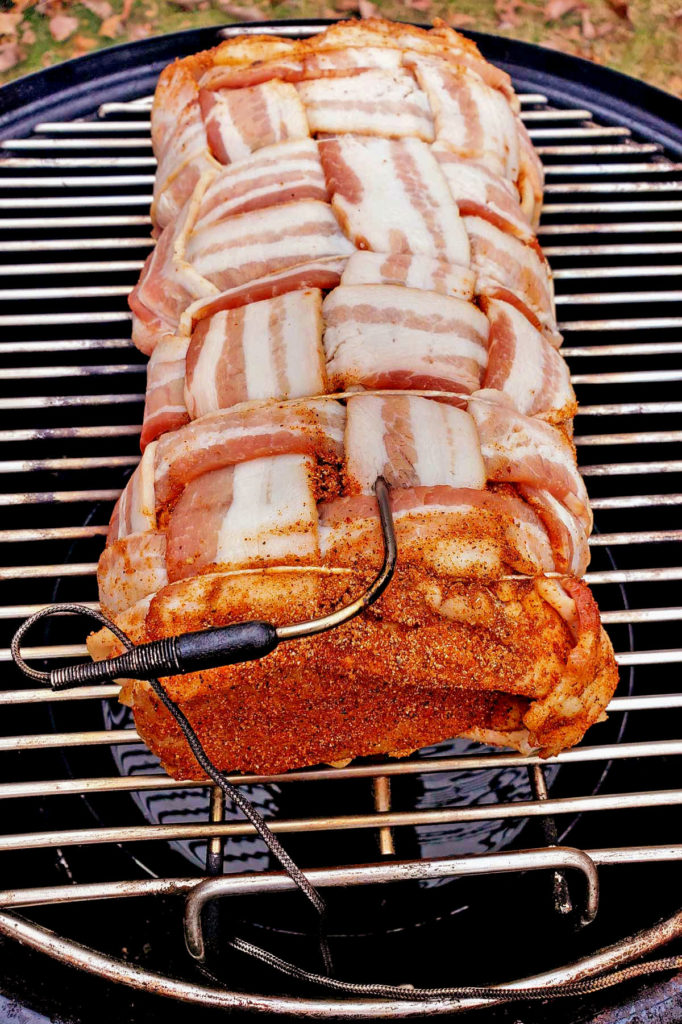 the pork loin on the smoker with thermometer meat probe