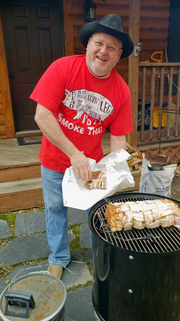 david putting the meat on the smoker