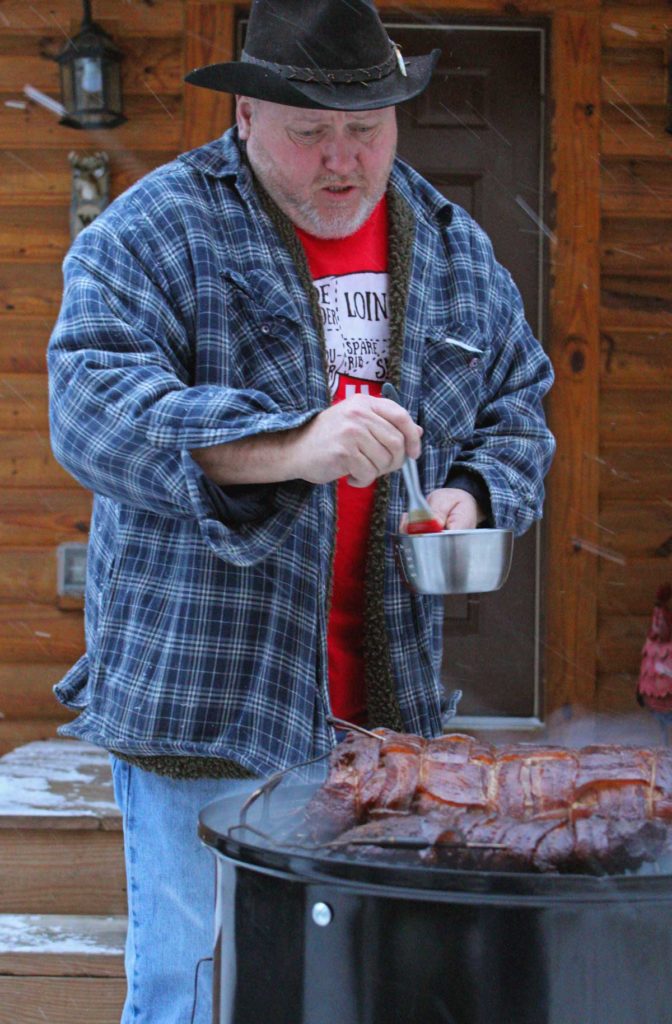 David saucing the meat