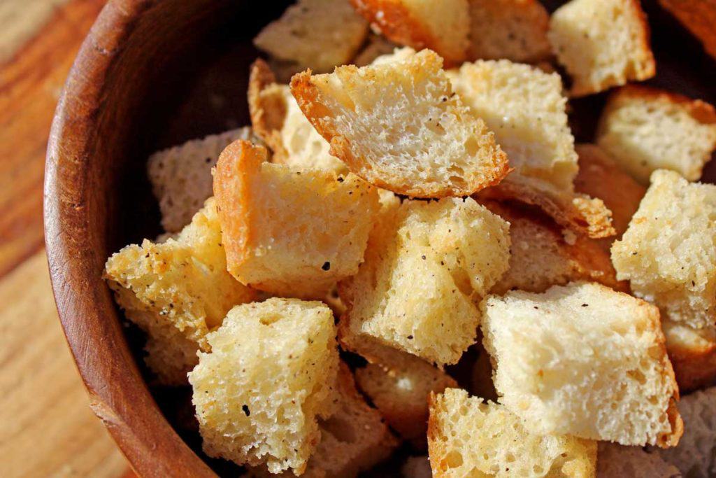A closeup shot of homemade croutons in a bowl.