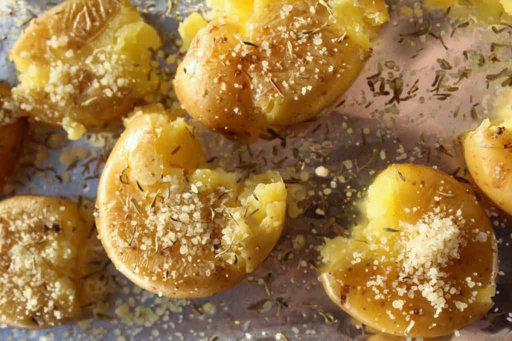 Smashed potatoes sprinkled with parmesan and thyme.