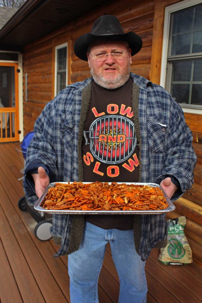 David holding a tray of snack mix