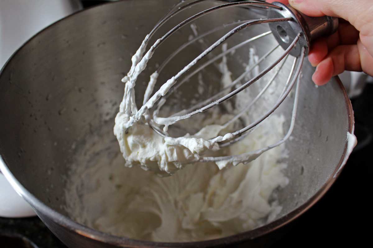 whipping cream in a bowl with a whisk
