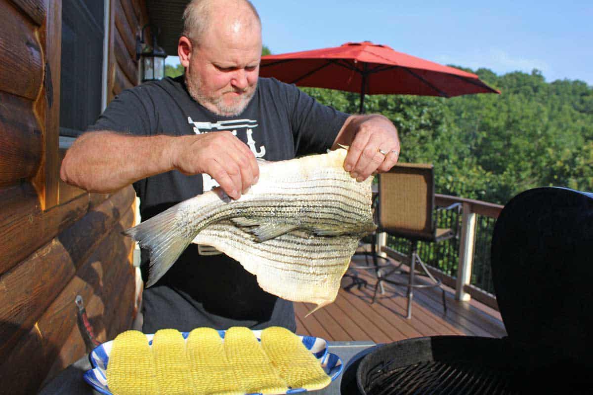 David placing the fish on the grill