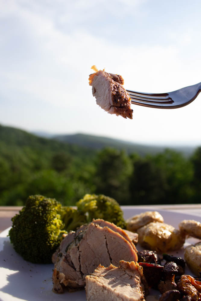 a bite of roasted pork tenderloin on a fork