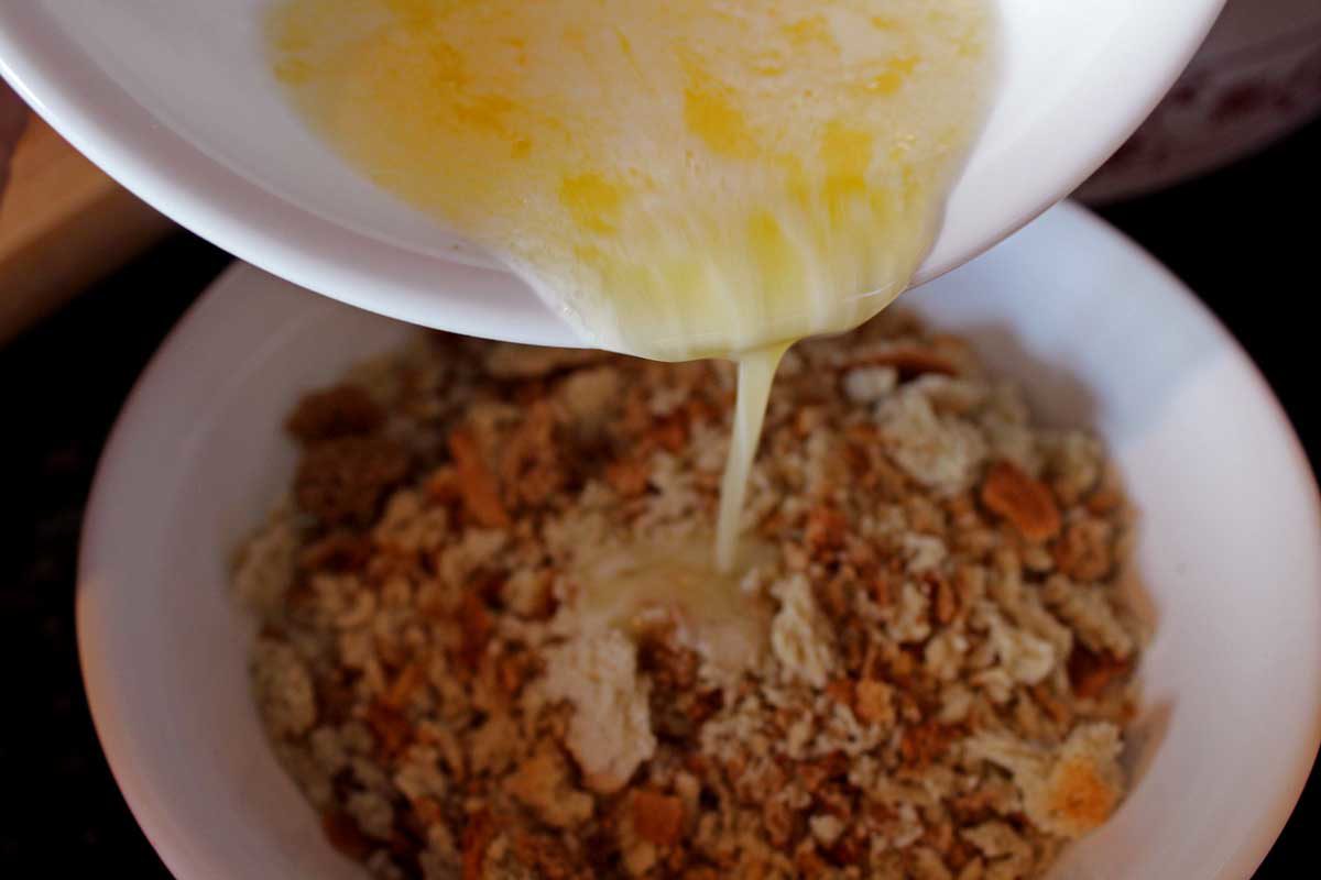 pouring butter into the stuffing
