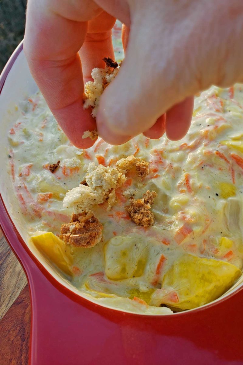 topping the squash casserole with stuffing mixture