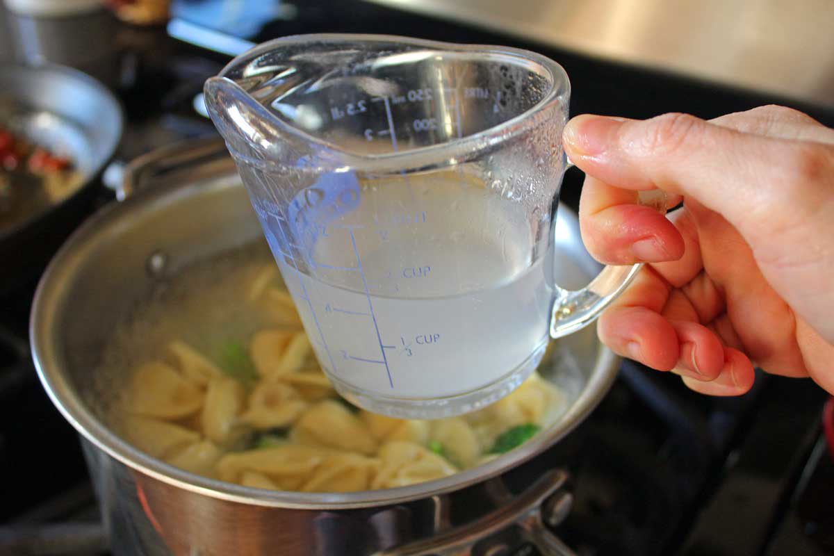 reserved pasta water in a measuring cup