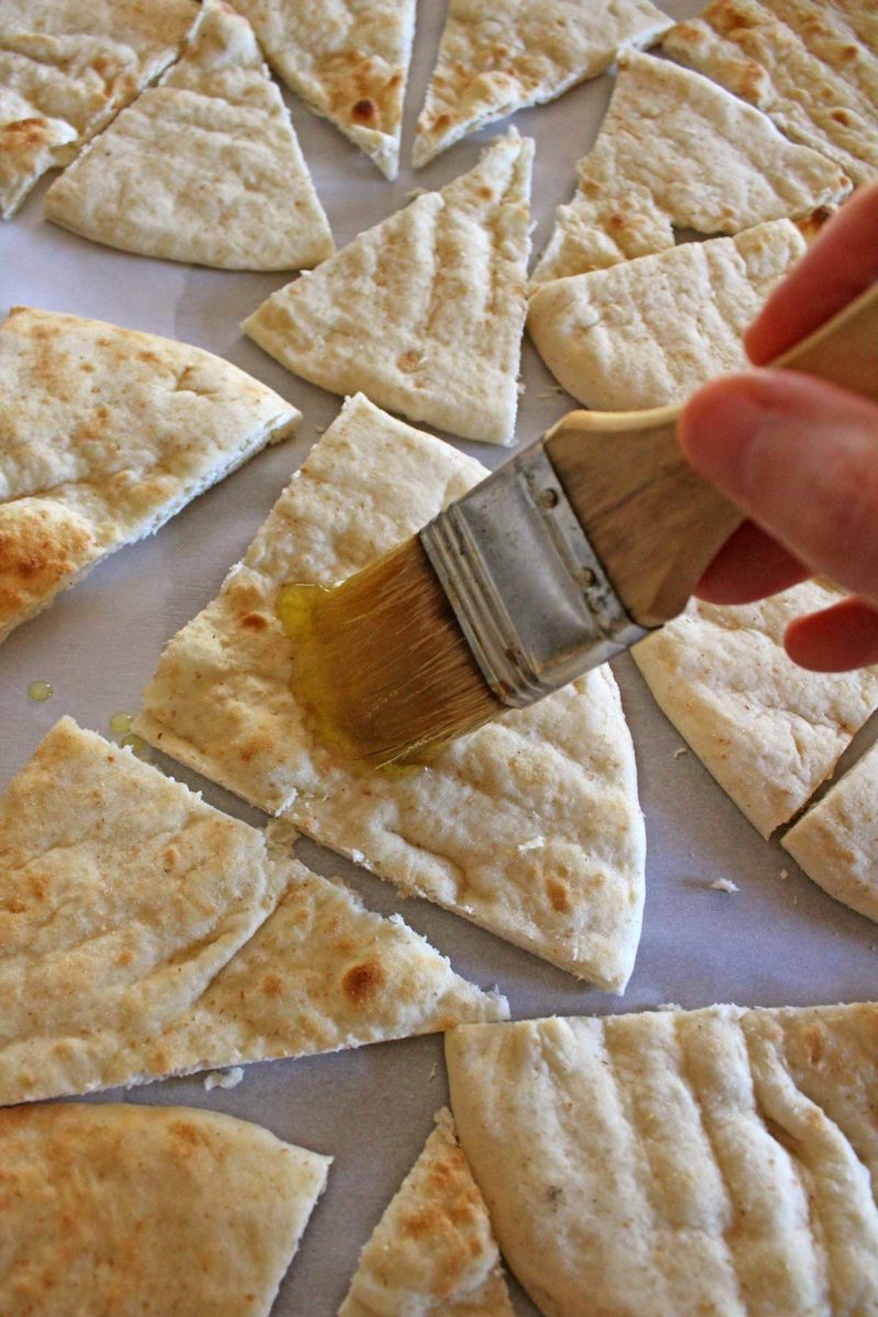 brushing pita bread with oil