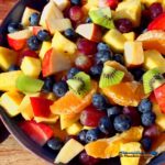 summer fruit salad mixed in bowl