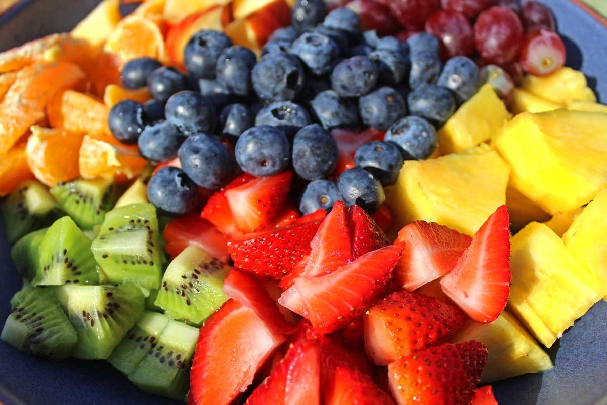 fruit and berries chopped inside a bowl