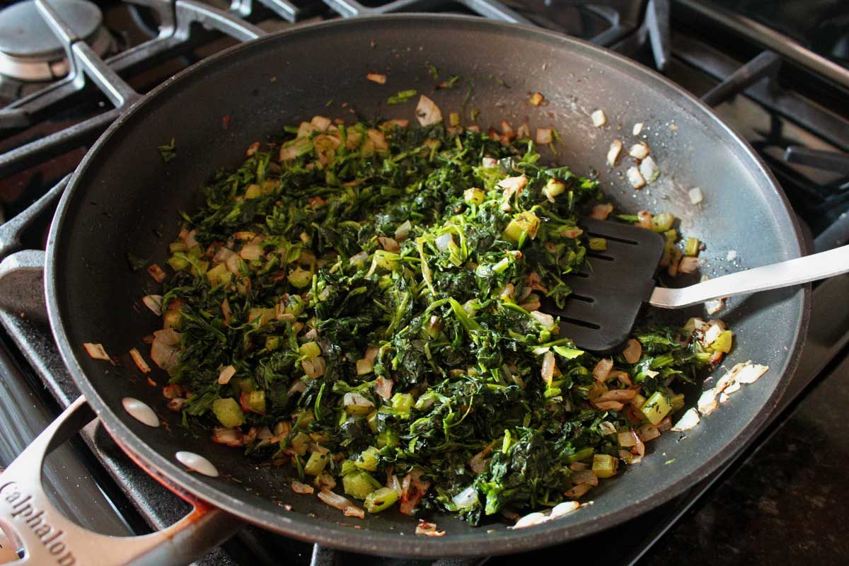 spinach and vegetables in pan