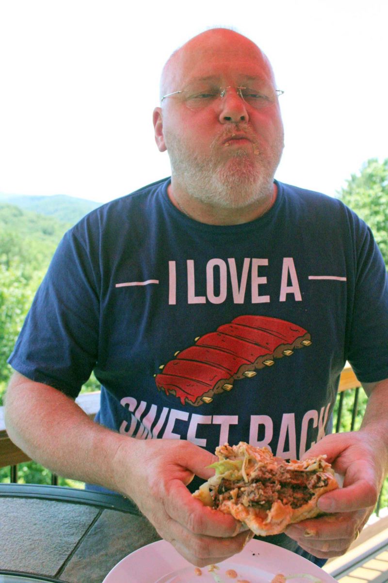 David having a foodgasm after biting into big twin double cheeseburgr