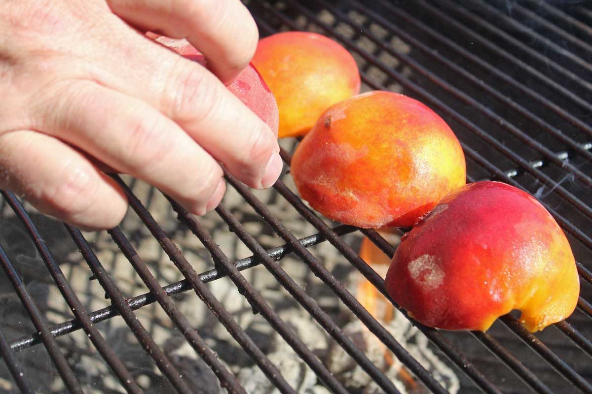 placing peaches on grill
