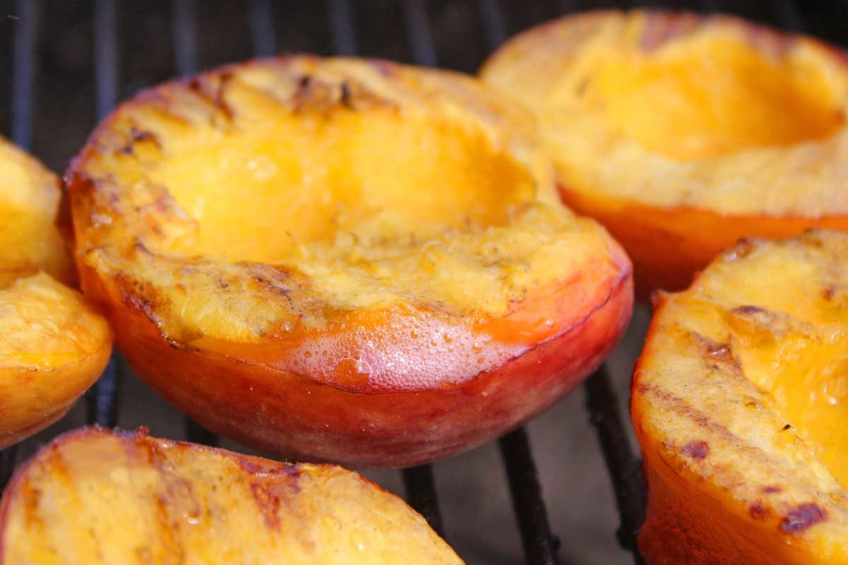 juicy grilled peach on grill