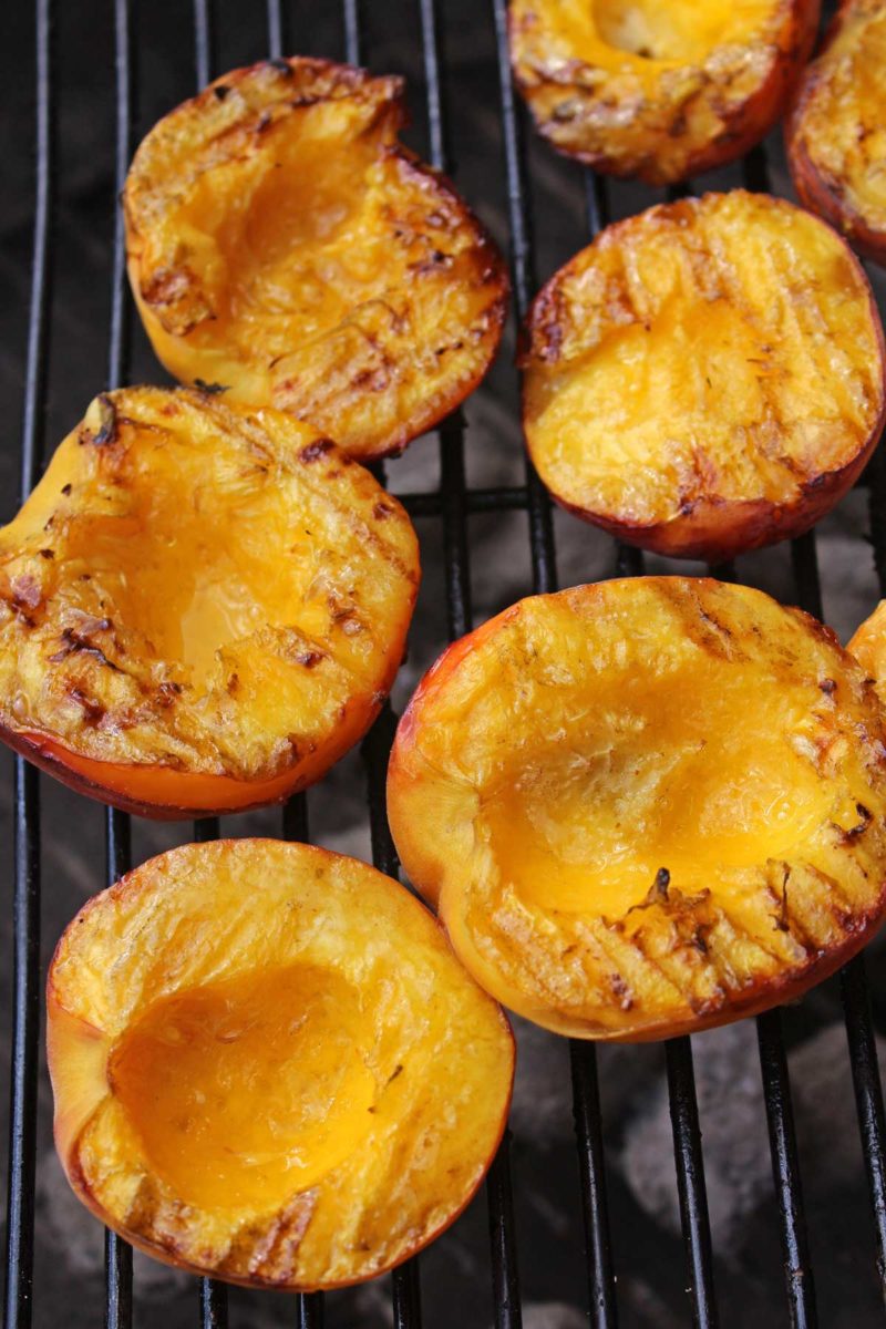 juicy grilled peaches on grill