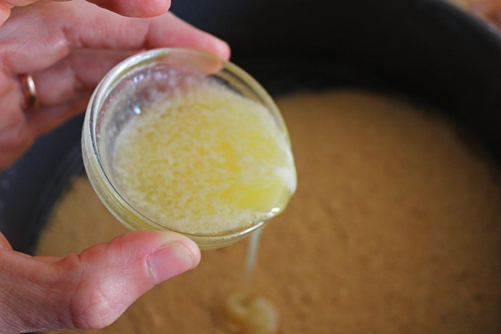 drizzling butter into graham cracker crumbs