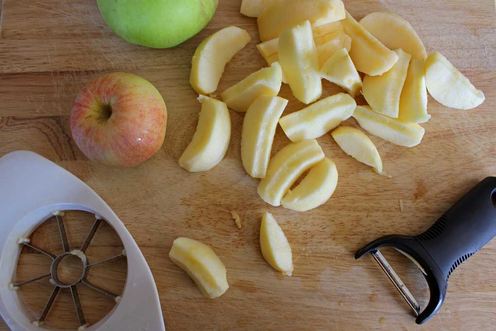 whole apples and sliced apples on cutting board