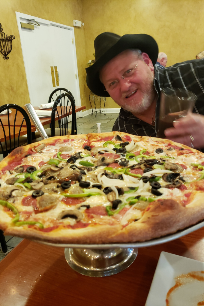 david admiring large pizza