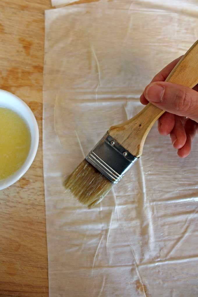 brushing phyllo dough with butter