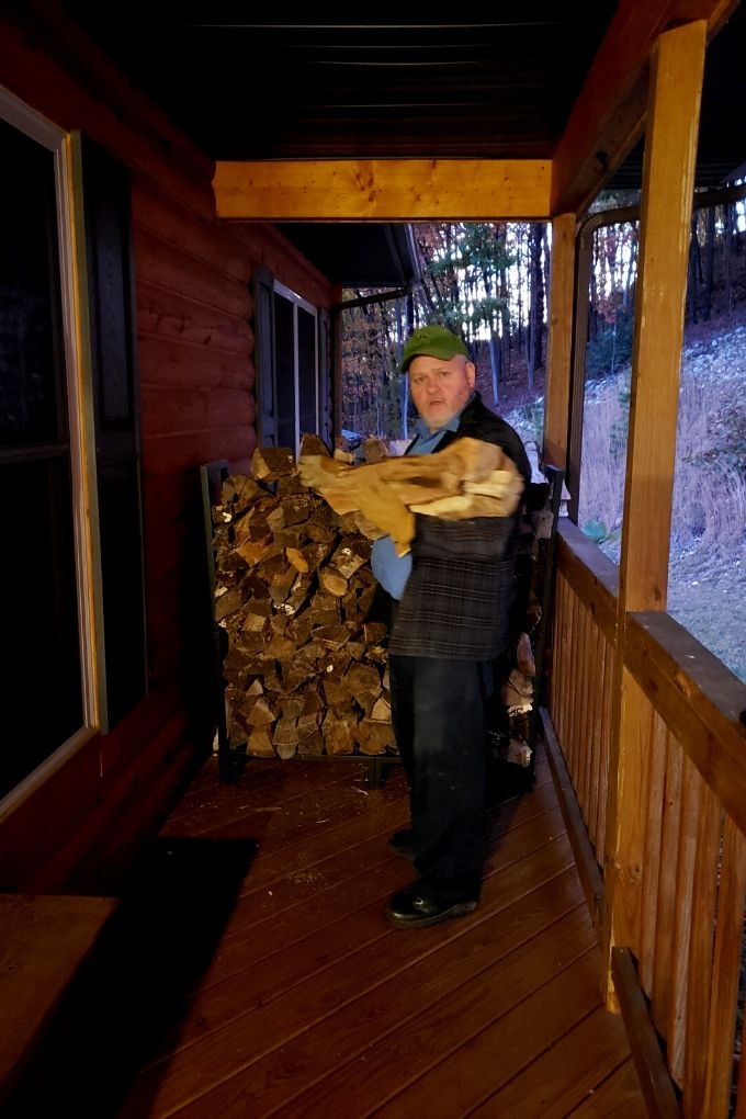 David putting firewood on porch